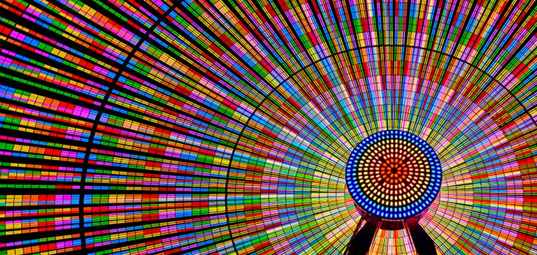 The Ferris wheel shines brightly with vibrant colors.
