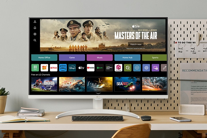 The video shows a smart monitor placed on the desk, with the screen transitioning in the order of webOS, home office, music, game, fitness, and sports.
