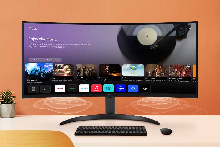 The smart monitor screen placed on the table displays the MUSIC APP screen.