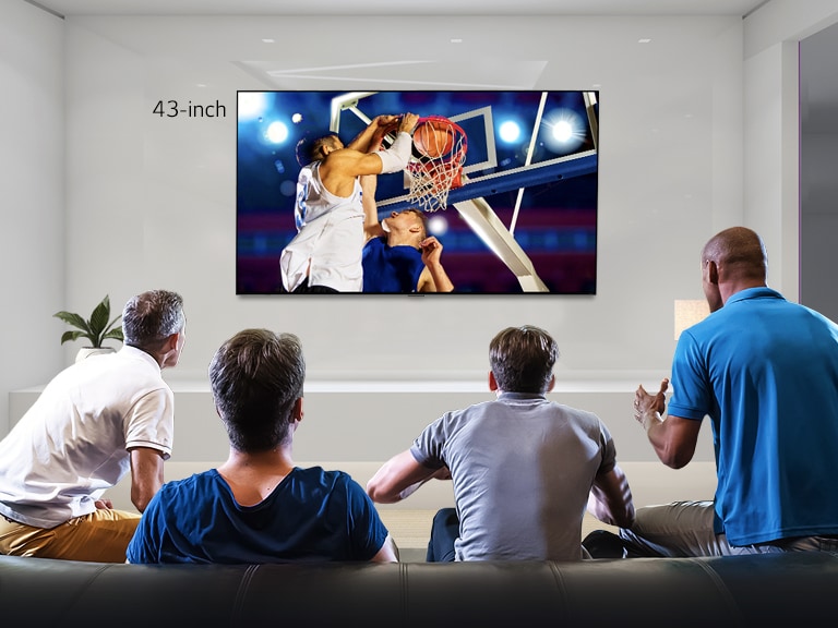 Rear view of a wall mounted TV showing a basketball game with four men watching. Scrolling left-right shows the difference in size between a 43-inch and 86-inch screen.