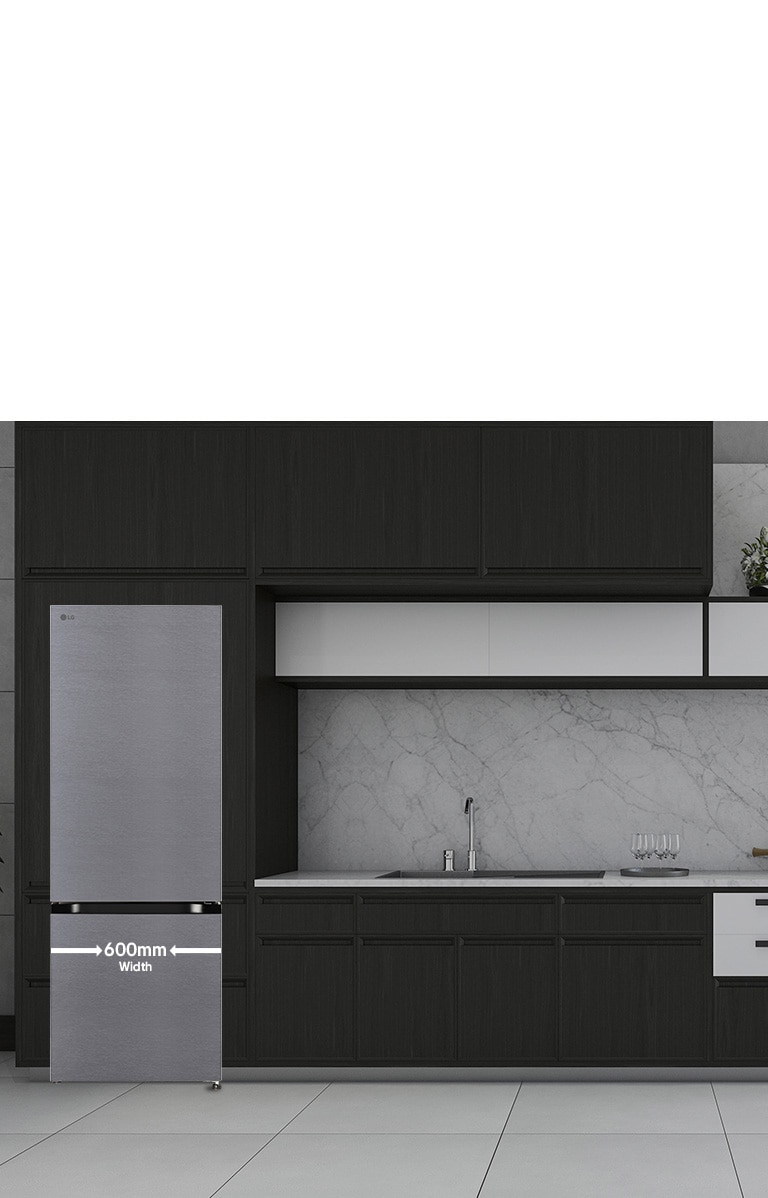 A close-up view of a kitchen featuring a sleek refrigerator, showing its 600mm width and modern design within the space.