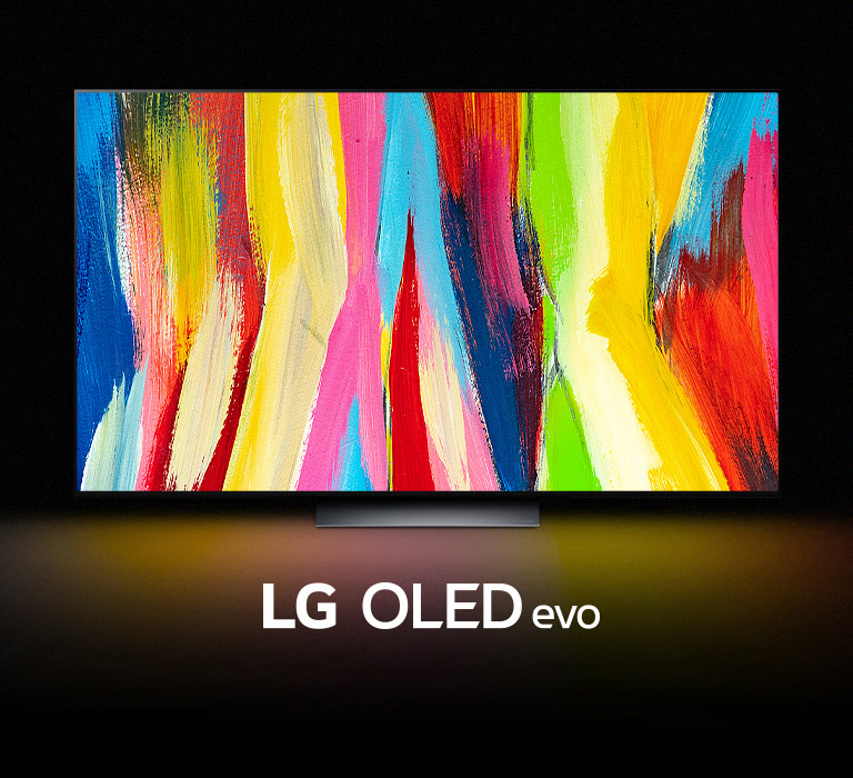 An LG OLED C2 is in a dark room with a colorful abstract artwork of vertical lines on its display and the words "LG OLED evo" underneath.