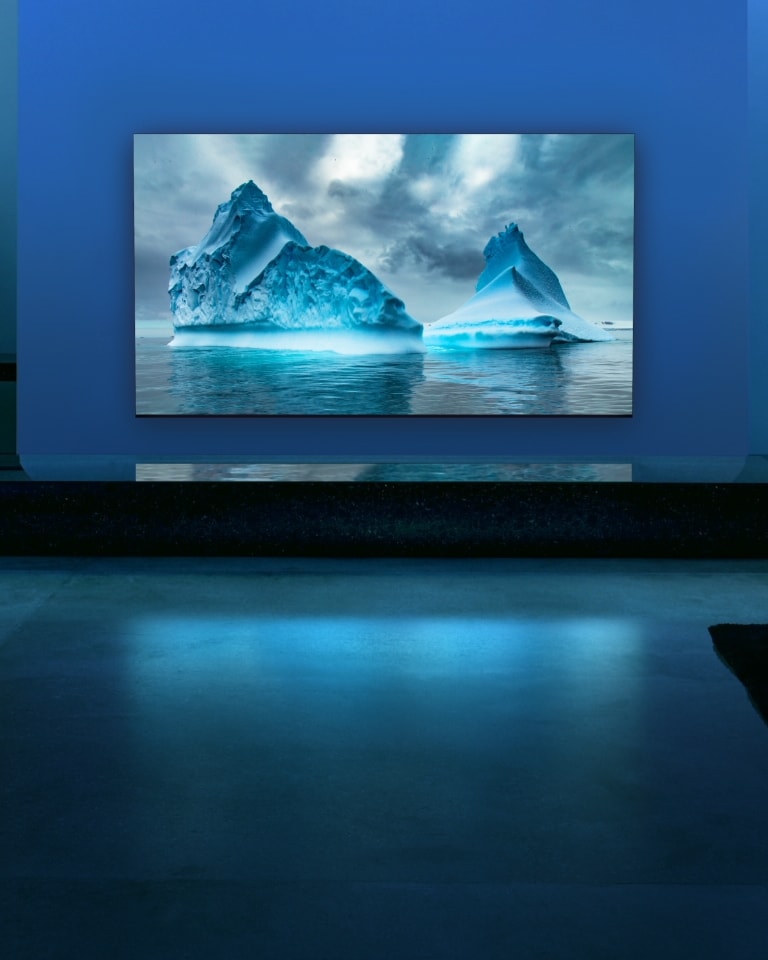 A blue neon circuit moves around on blue glacier image. The camera zooms out and shows this blue glacier within TV screen. The TV is placed in a wide living room with blue background.