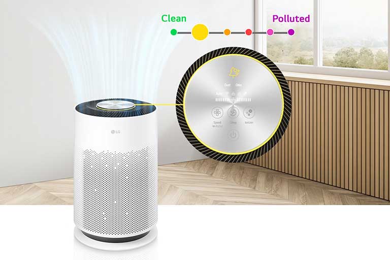 The front of the air purifier is visible, and an enlarged LED indicator is located on the right. Above the indicator, a line describing the air condition is visible. The window shows bad air, and the LED indicator shows a red light. This is a video showing the situation in which the air purifier operates, purifies the air, changes from orange to yellow and green, and the air in the house becomes clean.