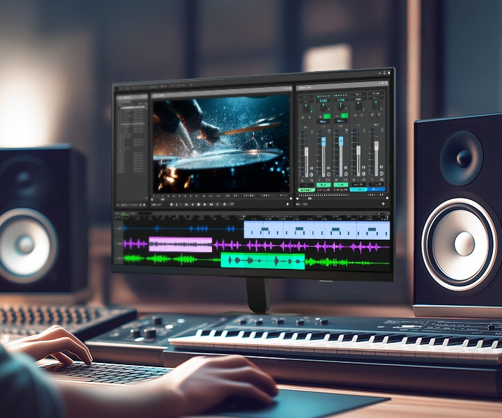 LG Smart Monitor displaying a professional video and audio editing workspace with timeline, color grading tools, and sound mixing interface, highlighting IPS 4K resolution, HDR support, and wide color coverage in a creative studio setup with speakers and keyboard for content production and multimedia work.