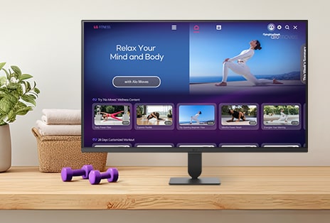 The LG Smart Monitor screen is showing various LG Fitness videos.
