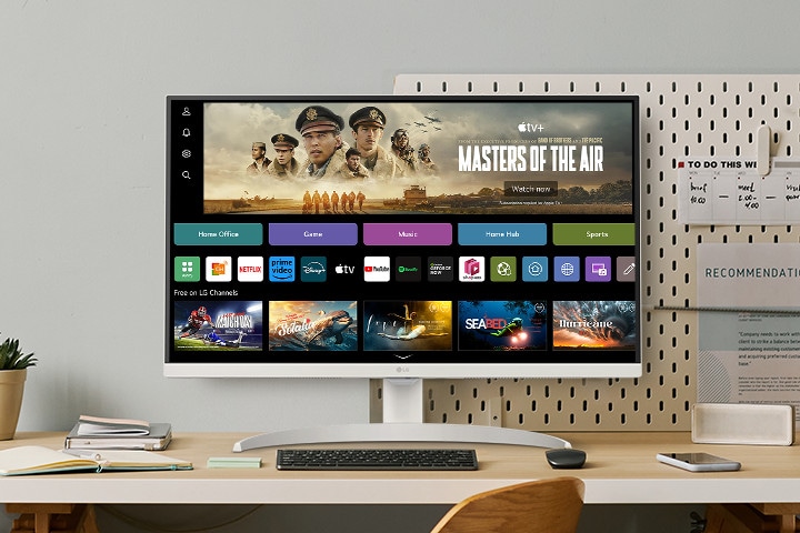 The video shows a smart monitor placed on the desk, with the screen transitioning in the order of webOS, home office, music, game, fitness, and sports.