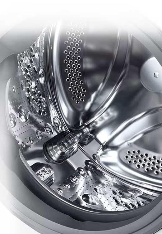  Tamburo interno di una lavatrice LG in acciaio inox lucido con fori e scanalature per il lavaggio efficace dei tessuti.