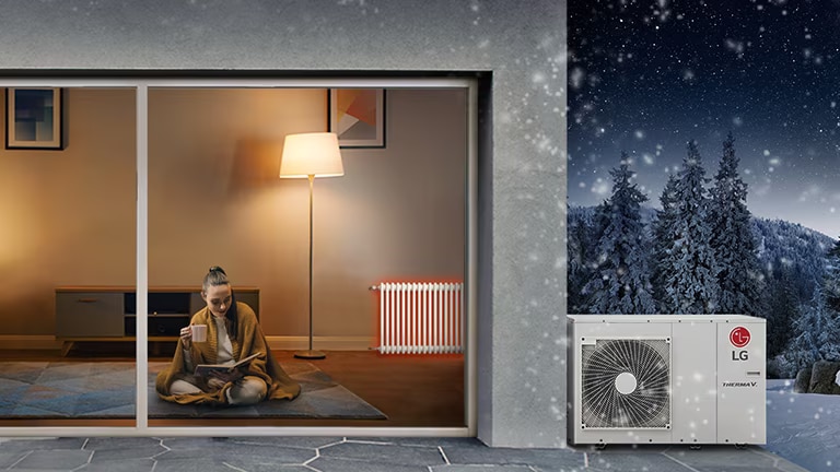 Fuori nevica, all'interno ci sono persone e fuori dall'edificio c'è la pompa di calore THERMA V