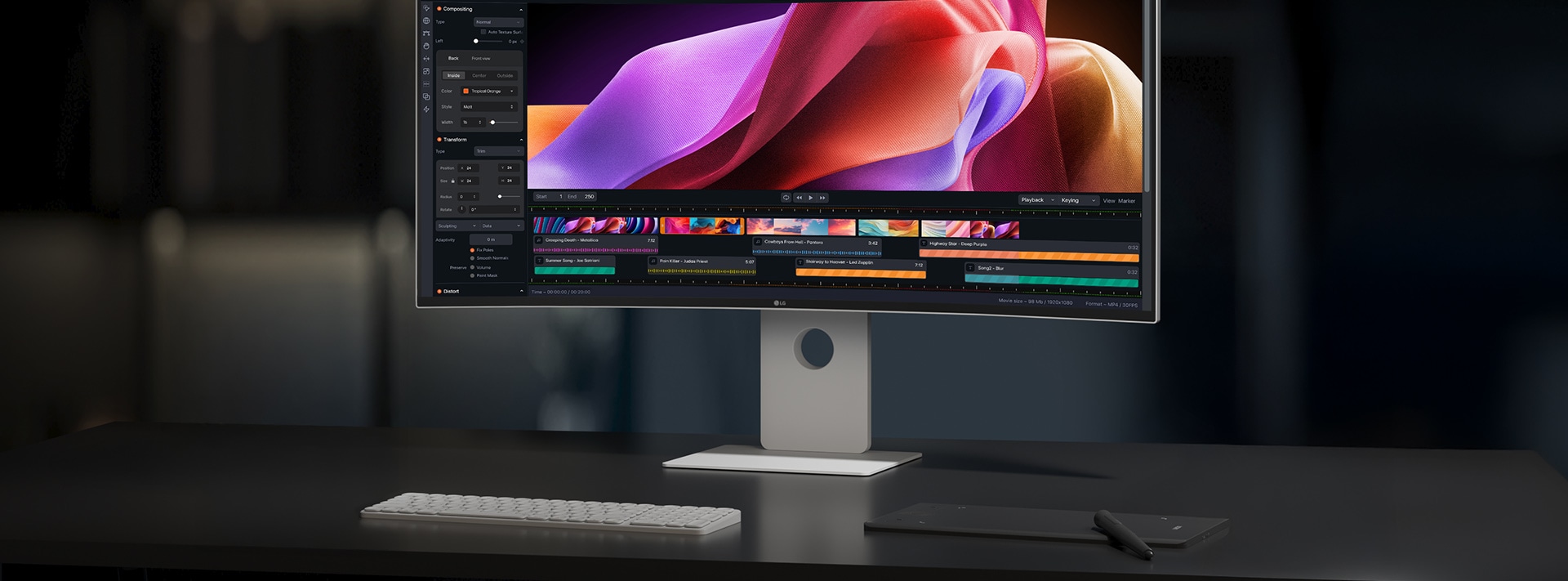 デスク上に、UltraFine™がキーボードとパッドとともに置いてある。画面には動画作成プログラムが映し出されている。