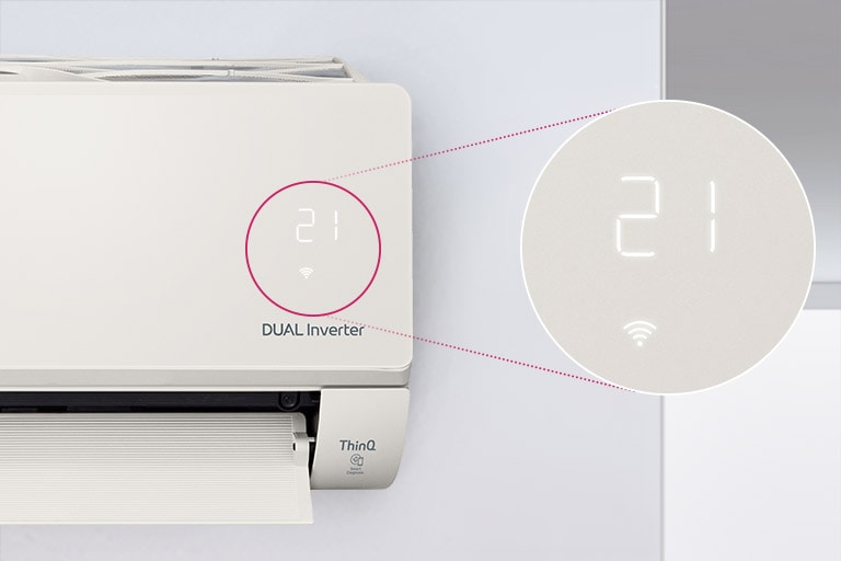 On peut voir à moitié le climatiseur LG installé sur le mur, la porte avant ouverte indiquant qu’il est en marche. Un cercle entoure les voyants de qualité de l’air de la machine et un cercle agrandi montre les voyants verts du panneau de qualité de l’air et les chiffres indiquant la qualité précise de l’air. Le logo DUAL Inverter est visible sur la machine.