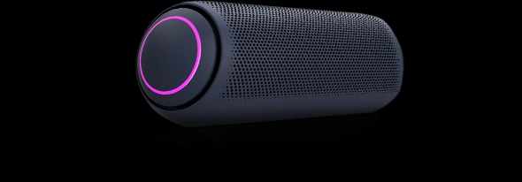 LG XBOOM Go PL7 with magenta lighting is placed on a grey surface.