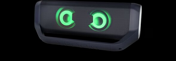 LG XBOOM Go PN7 with magenta lighting is placed on a grey surface.