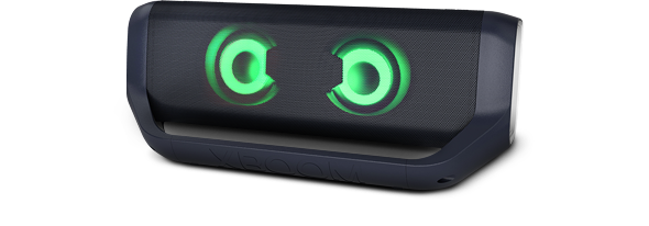 LG XBOOM Go PN7 with magenta lighting is placed on a grey surface.