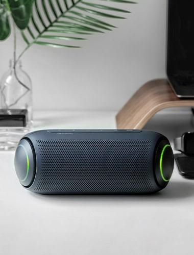Top-down view of the white LG XBOOM Go PL7 is placed on a black table