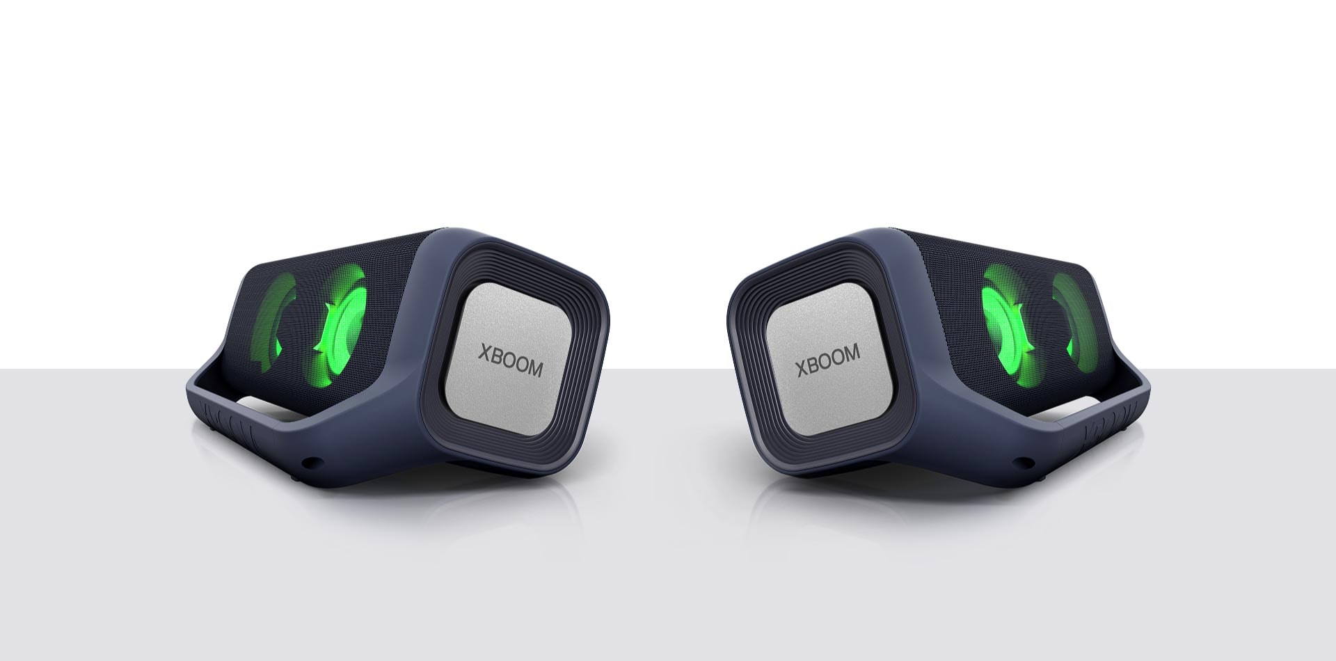 Two speakers with green neon light face opposite, and its woofers on their side is shaking based on its beats