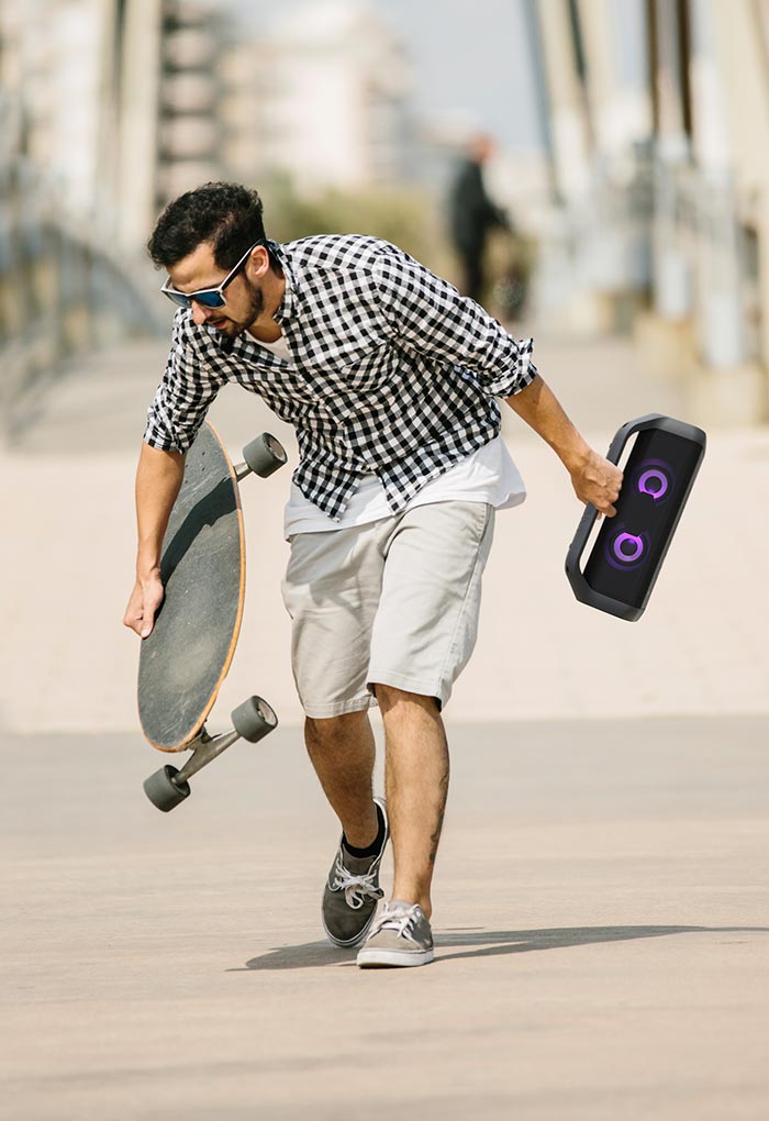 Pictures come up sequentially. Picture with a man skateboading holds a LG Xboom.