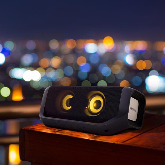 Another picture comes up, Xboom is displayed on the table outdoor. The background seems city at night.