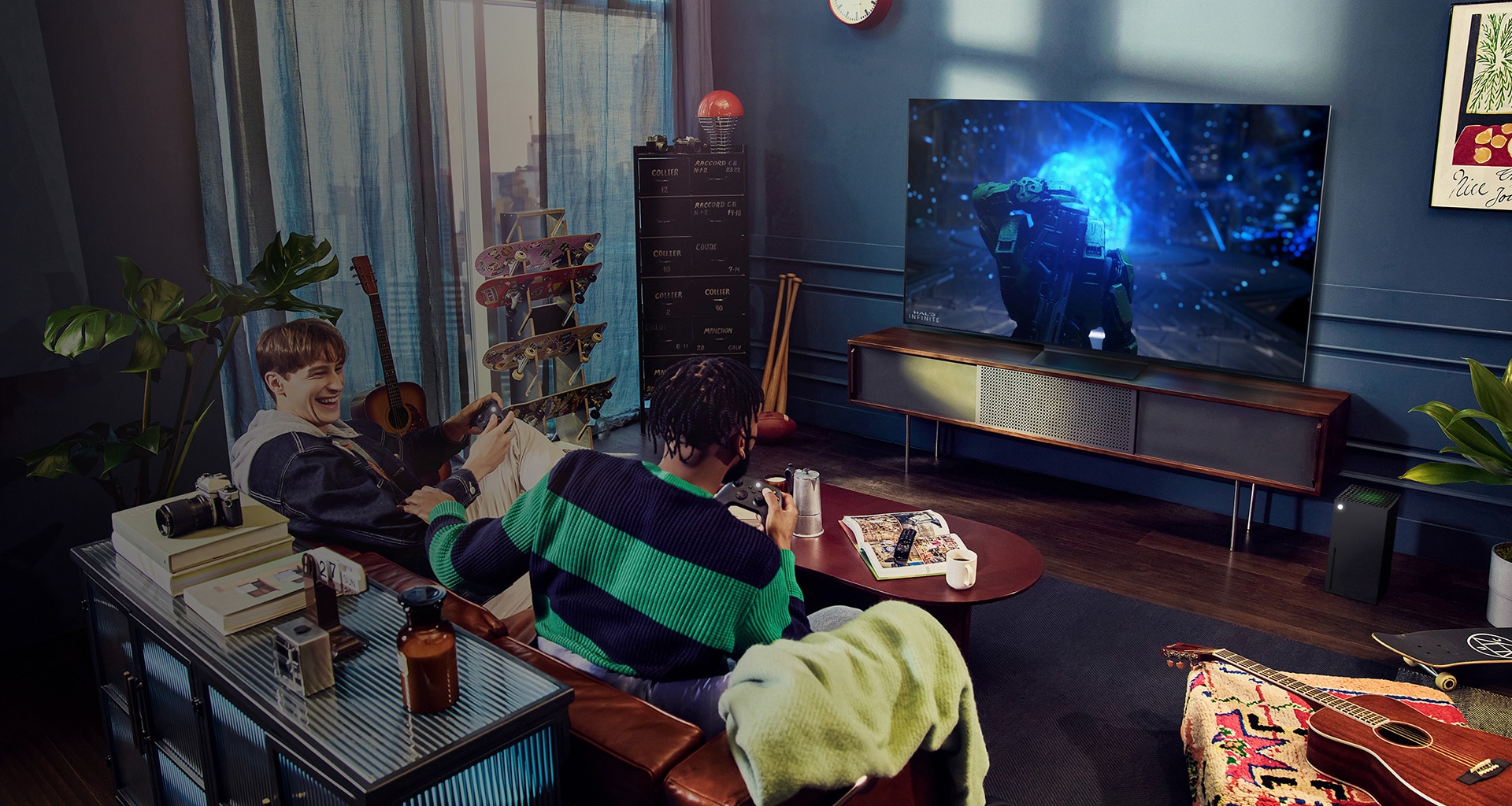 People play a game with a controller on the LG OLED television
