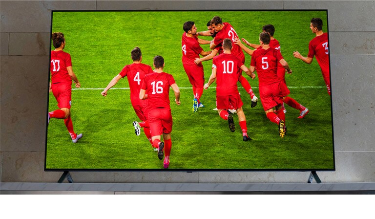 Un téléviseur NanoCell est posé sur un meubl télé. Des joueurs de football se congratulent.