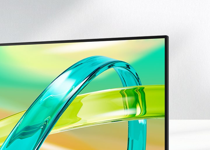 LG FHD monitor displays a green and yellow gradient background with a translucent curved object floating across the screen.