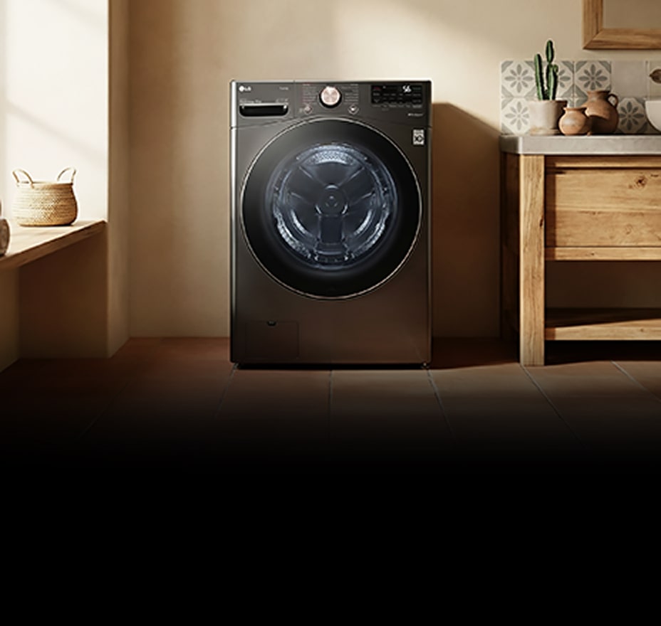 A white front-loading washer sits beneath a wooden shelf, surrounded by neatly placed towels and decor.