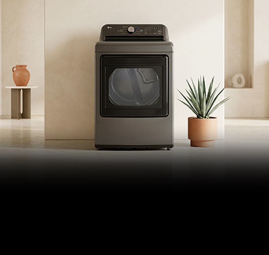 A white front-loading washing machine is installed in a bright laundry room with pastel cabinetry and a window.