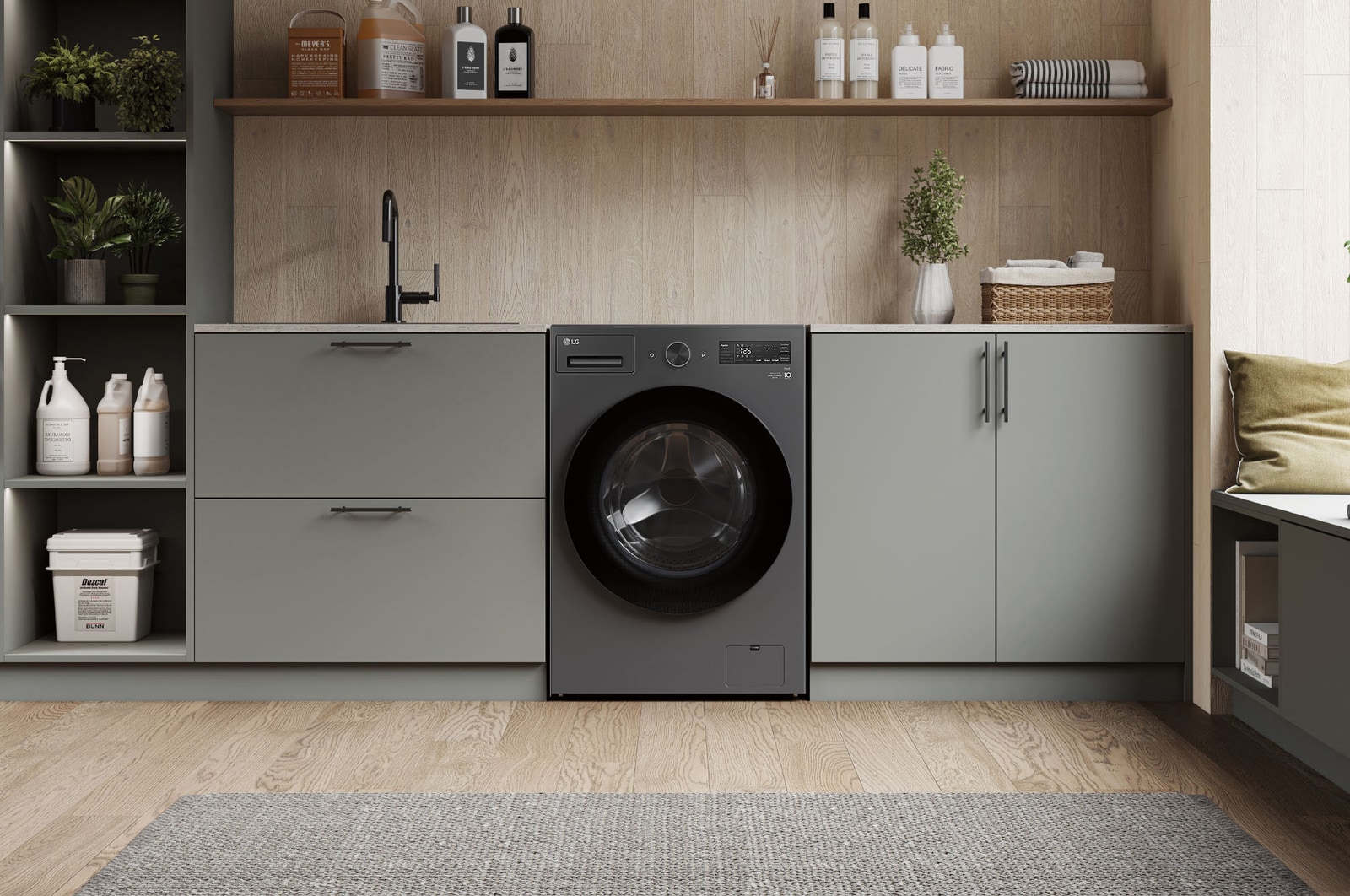 Lavasecadora LG WD16EGNTS6P Grafito Esencia, instalada bajo encimera en un moderno cuarto de lavado con gabinetes verde grisáceo y encimera de madera.