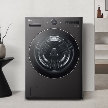 Lavasecadora LG WH25BFXS6B Negro Mate, integrada elegantemente en un baño o cuarto de lavado moderno y minimalista con paredes claras y acentos oscuros.