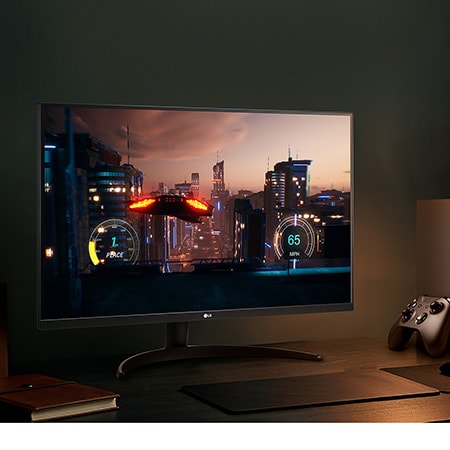 Monitor LG 32UR500K en acabado negro mate con resolución 4K UHD, mostrando un juego de carreras inmersivo conectado a una consola en un entorno de gaming elegante y oscuro.
