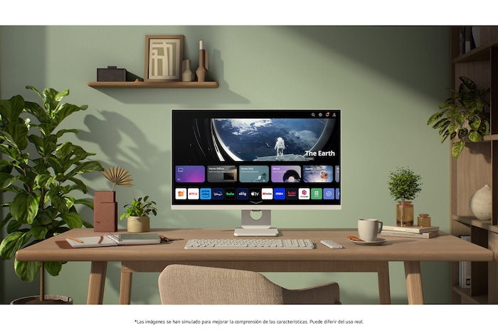 Monitor Inteligente LG 27U511SA en acabado blanco con webOS Smart Hub, mostrando aplicaciones de streaming para entretenimiento en un moderno entorno de oficina en casa con plantas