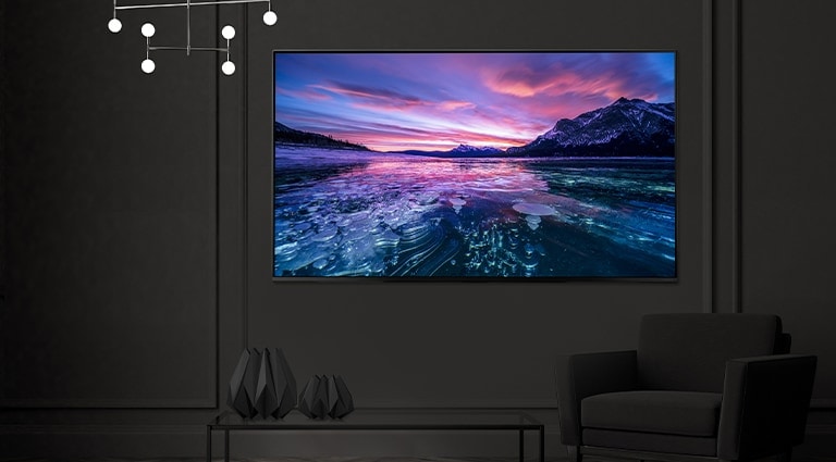 A TV is hanging on the wall of the hotel room, and the TV screen is bright and clear.