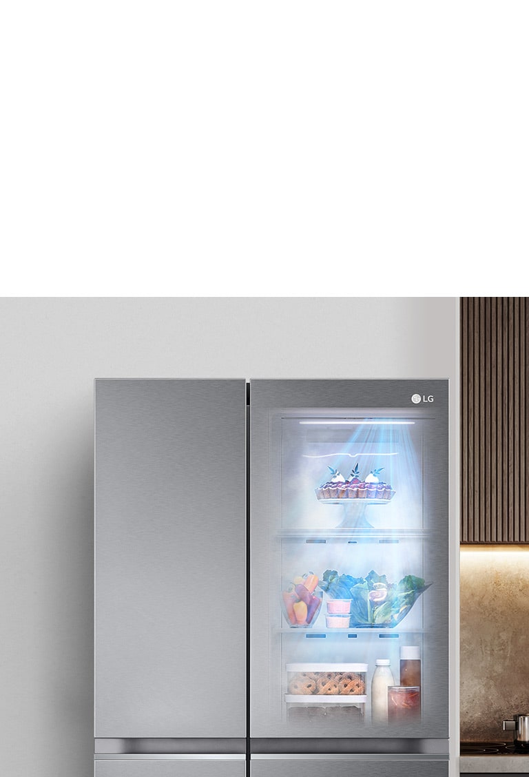 The front view of a black InstaView refrigerator with the light on inside. The contents of the refrigerator can be seen through the InstaView door. Blue rays of light shine down over the contents from the DoorCooling function.
