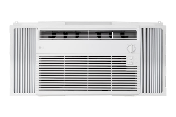Window air conditioner installed in a living room with a sofa and plants