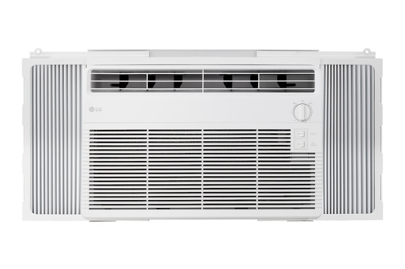 Window air conditioner installed in a living room with a sofa and plants