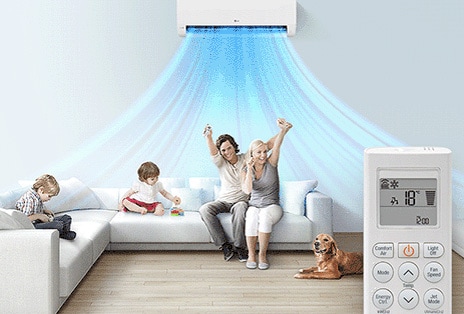 A family is a room with the LG AC on. In the foreground is a remote control showing the buttons and temperature.