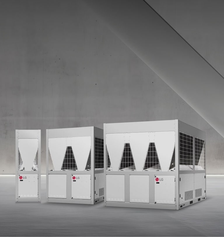 Three LG inverter scroll chillers are displayed in a space with minimalist concrete walls and soft lighting. 