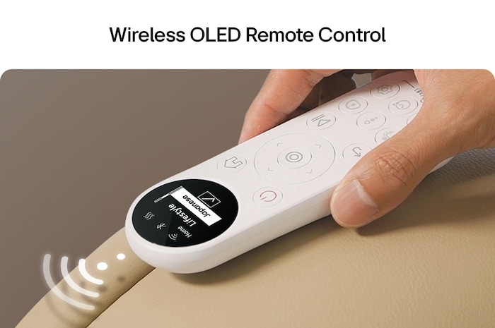 White OLED remote with circular buttons magnetically attached to a beige armrest, display visible at a glance.