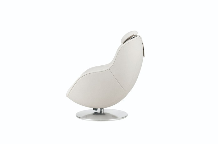Profile view of white massage chair on a pedestal showcasing its smooth curved form and headrest contour.