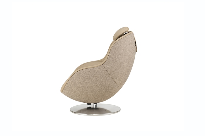 Profile view of white massage chair on a pedestal showcasing its smooth curved form and headrest contour.