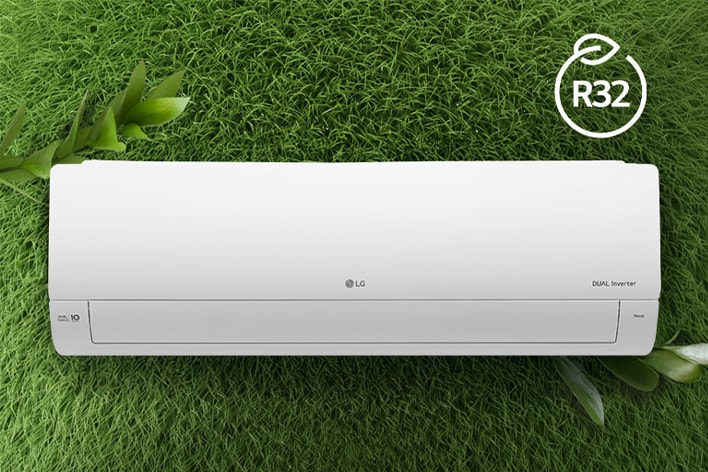 The LG Air conditioner is installed on a wall of grass. The R32 logo for energy efficiency is in the upper right corner.