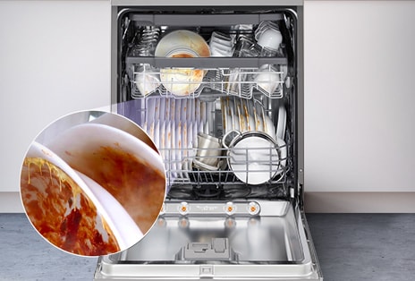 A Free-Standing dishwasher with the door fully open, revealing dirty dishes inside.