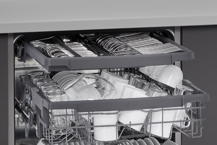 Showcasing how spatulas, spoons, forks, and knives are arranged in the 3rd rack of an LG free-standing dishwasher.