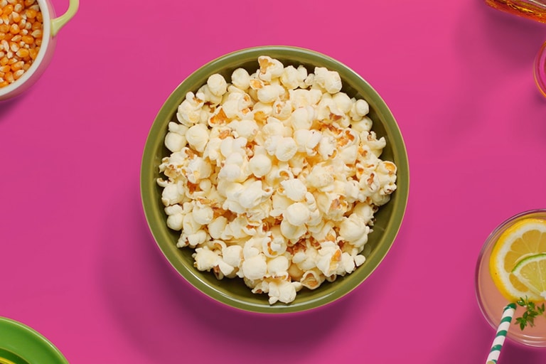 The animation shows that a bowl of popcorn is being cooked faster by  LG NeoChef™ than the other one being cooked with conventional microwave oven.