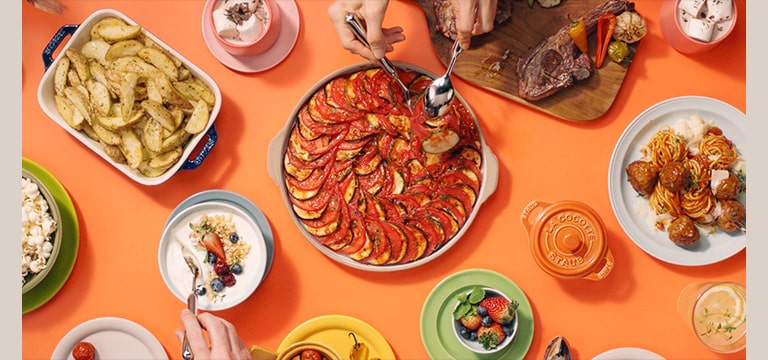 It show various dishes set on the table cooked with LG NeoChef.