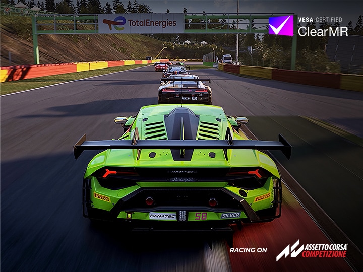 A racing game scene showing a bright green sports car leading on a track, with multiple cars following behind under the AMD FreeSync Premium feature.	