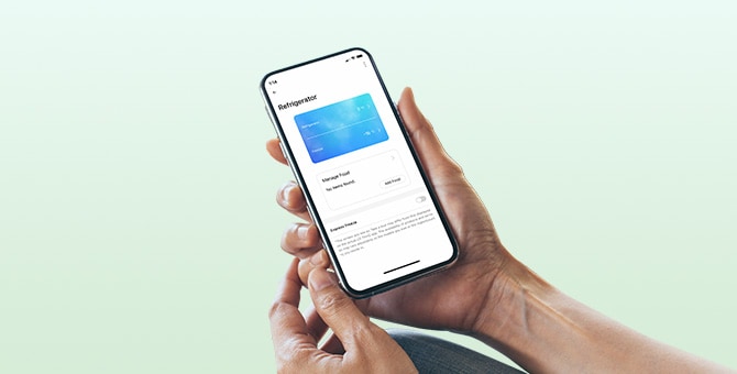 Hands holding a phone with LG ThinQ app on