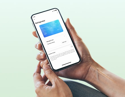 Hands holding a phone with LG ThinQ app on