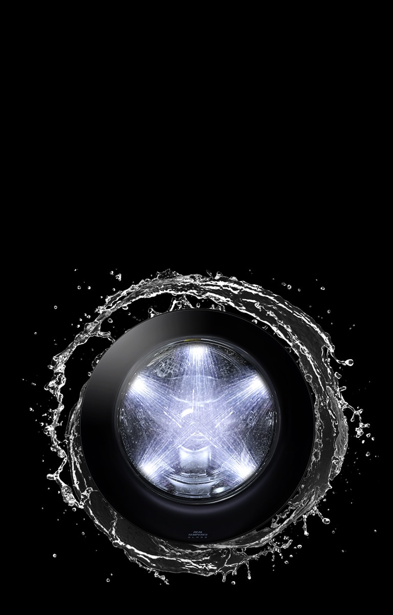 There is a washing machine door, around which the water stream is spinning dynamically. Water spouts from five directions from the inside of the washing machine.