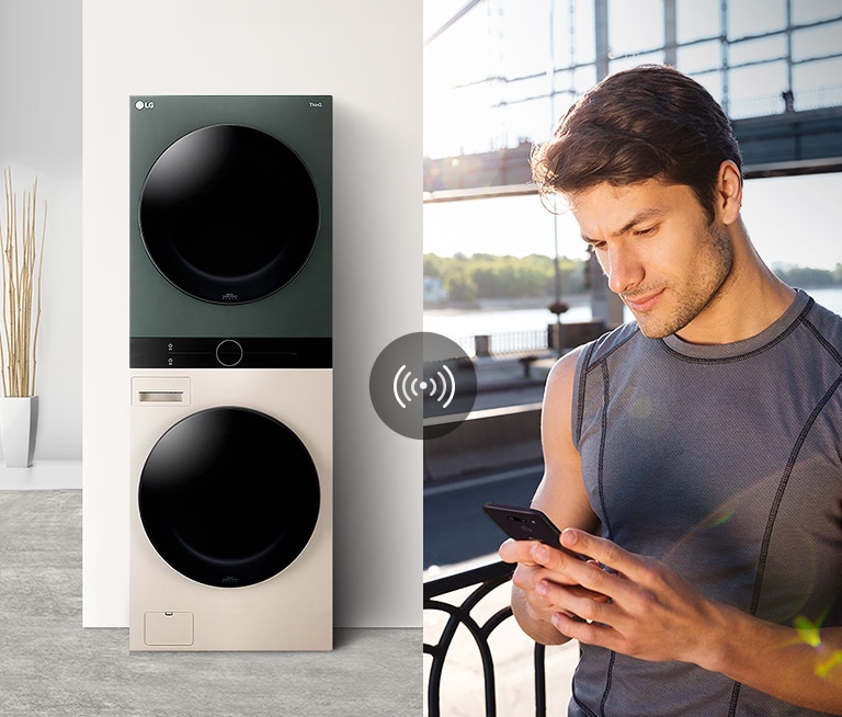 A man outdoors is checking the condition of the WashTower at home via the LG ThinQ app.